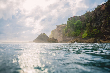 Fototapeta na wymiar Ocean and cliff in Uluwatu with sunshine. Bali, Indonesia