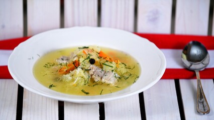 Vegetable soup on a plate on the wooden table