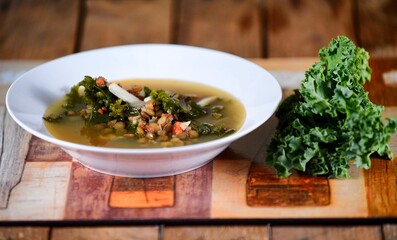 Vegetable soup on a plate on the wooden table