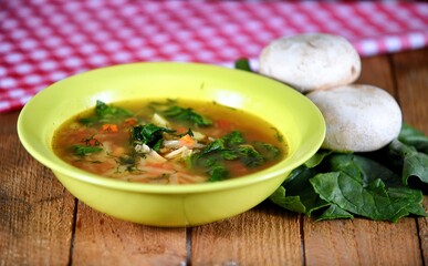 Vegetable soup on a plate on the wooden table