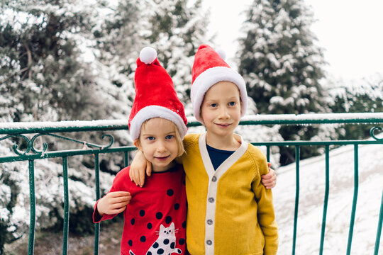 brother and sister posing for a photo at Christmas time 