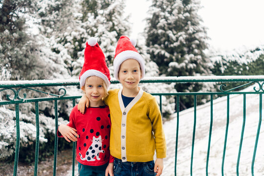 brother and sister posing for a photo at Christmas time 