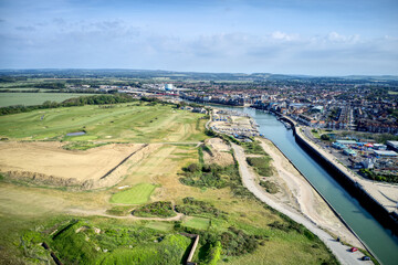 The River Arun running between the links golf course and the resort town of Littlehampton. Aerial view.