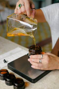 Woman perfumer creating an aroma oil scent