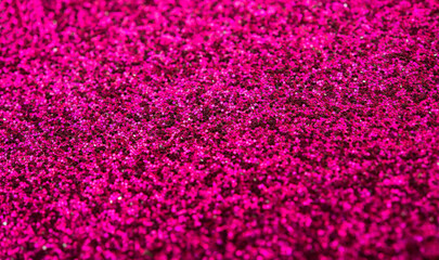 Closeup of pink giltter making into a dark background