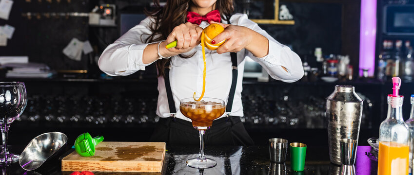Anonymous stylish young woman preparing alcoholic cocktail in modern bar - Powered by Adobe