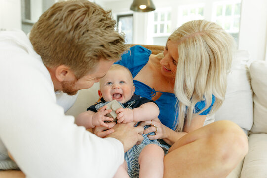 Parents playing with their son