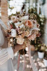 Wedding flowers in hand of a bride. Bouquet of flowers representing marriage and love.