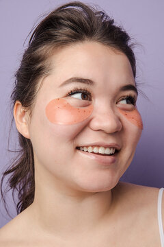 Young brunette east asian woman wearing  skincare under eye patch