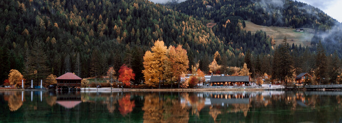 Reflection of mountain and trees on lake in dolomite