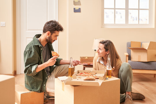 Man speaking with girlfriend during lunch in new flat