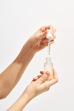 Woman with bottle of face serum