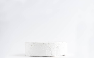 White round pedestal podium. Abstract cement pedestal by spotlights on white background