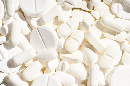 Pharmacy concept background with white pills