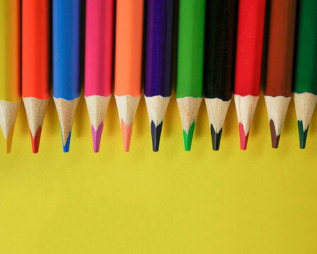 Back to school, education. Back to school yellow background pencils lined up in a row. View from above. copy space