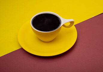Closeup view of yellow cup filled with black coffee