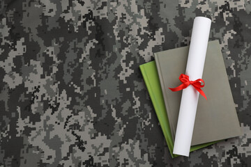 Books and diploma on camouflage background, top view with space for text. Military education concept
