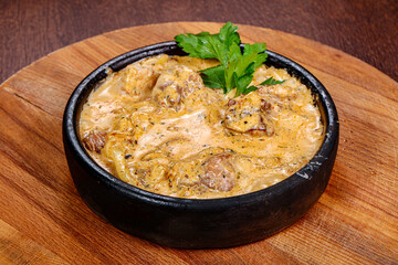 Pork with cream sauce in the pot