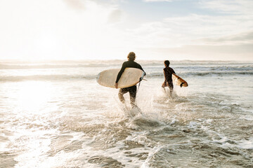 Anonymous surfer friends at the beach with surfboards