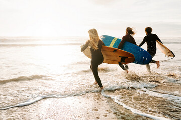 Surfer friends at the beach with surfboards