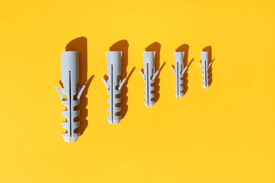 Set of dowels on yellow background with shades