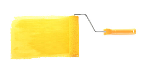 Applying yellow paint with roller brush on white background, top view