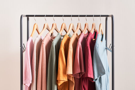 Variety of clothes on rail.