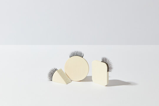 Beige makeup sponges and false eyelashes