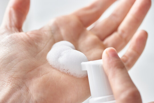 Incognito applying soap on hand.