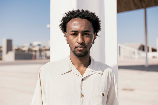 Black man in linen shirt.