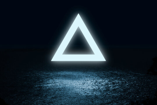 triangle of light fluctuate over the water