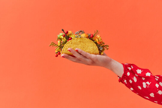 Woman holding taco with flowers