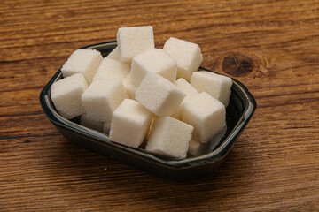 Refined white sugar cubs in the bowl
