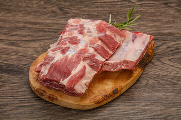 Raw pork ribs served rosemary