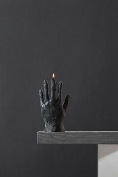 Black candle in shape of hand
