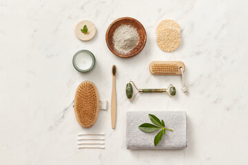 Face roller, cream and brush on table