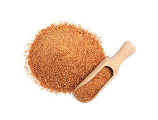 Natural coconut sugar and wooden scoop on white background, top view