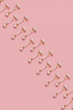 Face rollers on pink background