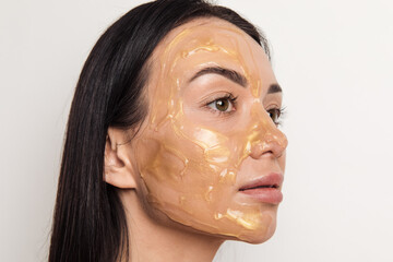 Woman with gold gel facial mask 