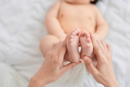  Feet of an infant, mom will embrace the baby with her arms.