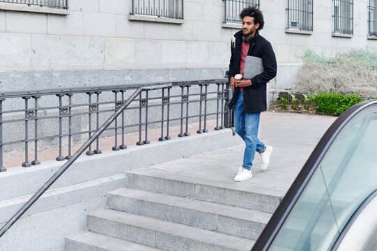 Man walking down subway steps during his commute