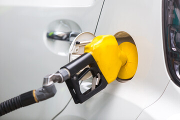 Petrol pump filling nozzles at the gas station in a service