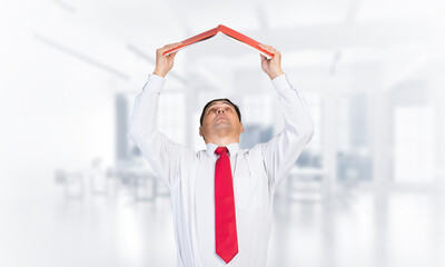 Senior businessman holding open book