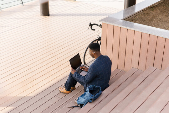 Young businessman using a laptop outdoors 