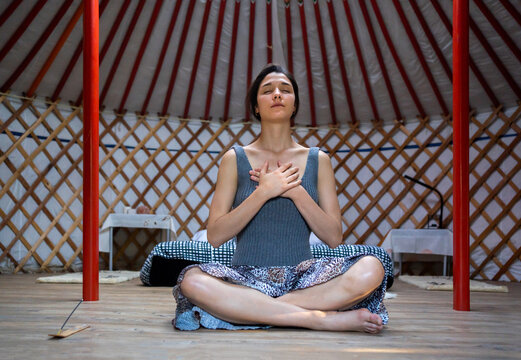 Woman Doing Meditation In A Yurt. 
