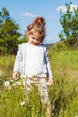 Toddler Girl with Curly Hair and Denim Hat in the Summer