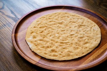flatbread pita on a round wooden cutting board. bakery. flat bread