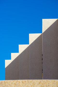 Triangular shadows and lights on a facade.