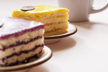 Berry and lemon cakes and a mug in a row, selective focus.