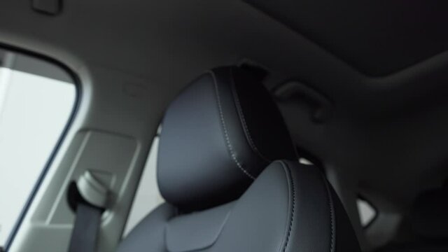 The interior of a luxury car with leather upholstery seats.